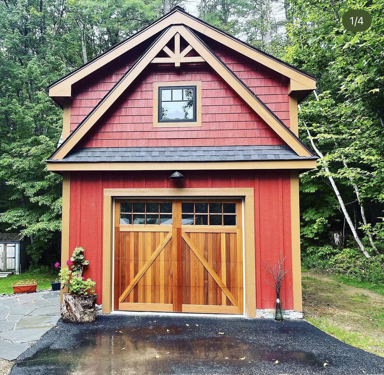 Red board-and-batten custom garage barn with cedar carriage doors built in New Hampshire