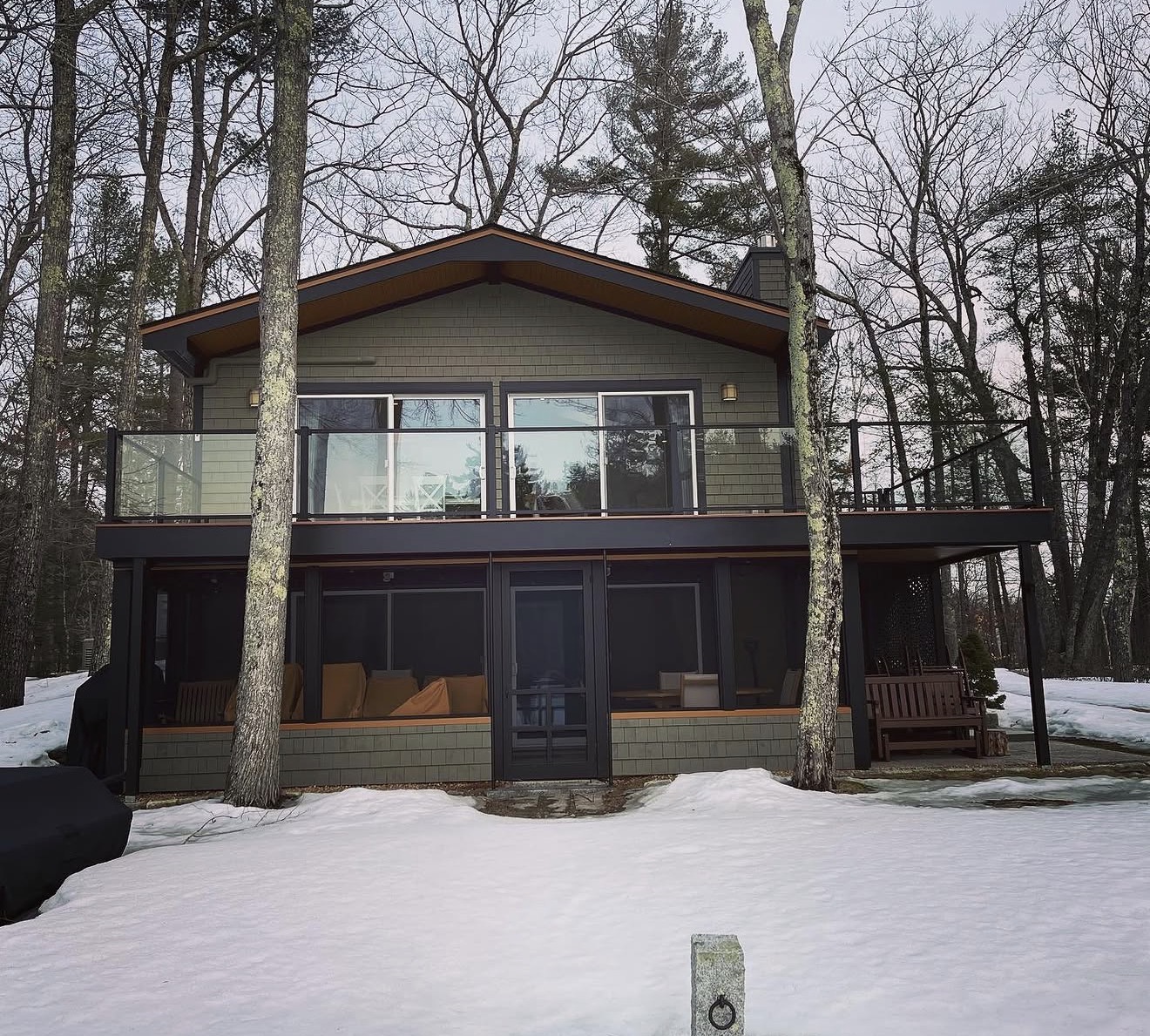 Lakeside chalet with screened porch and deck in winter near Squam Lake, New Hampshire