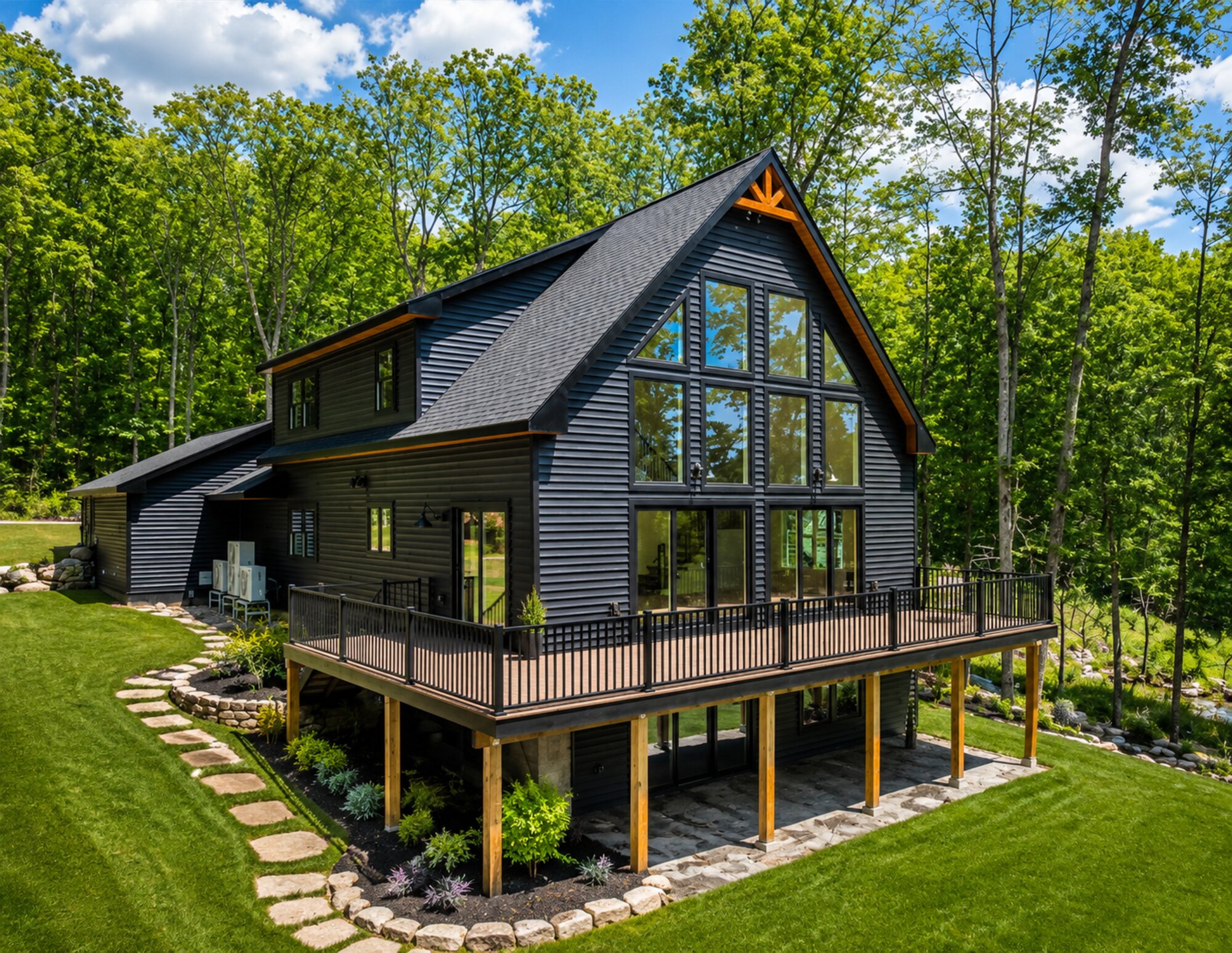 Custom chalet-style home with floor-to-ceiling glass gable and timber accents, built by Catalpa Carpentry in Northern New Hampshire