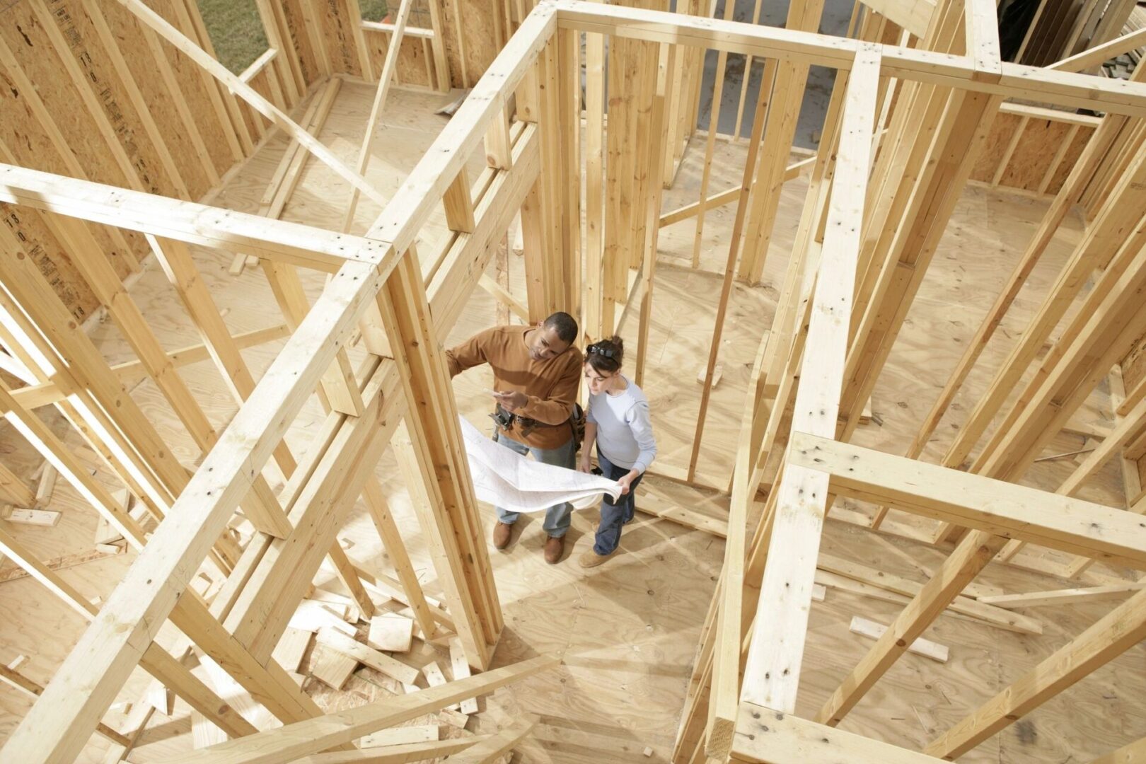 Two persons inside, a house being built